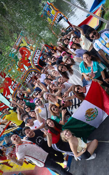International travelers enjoying a Xochimilco boat party in Mexico City
