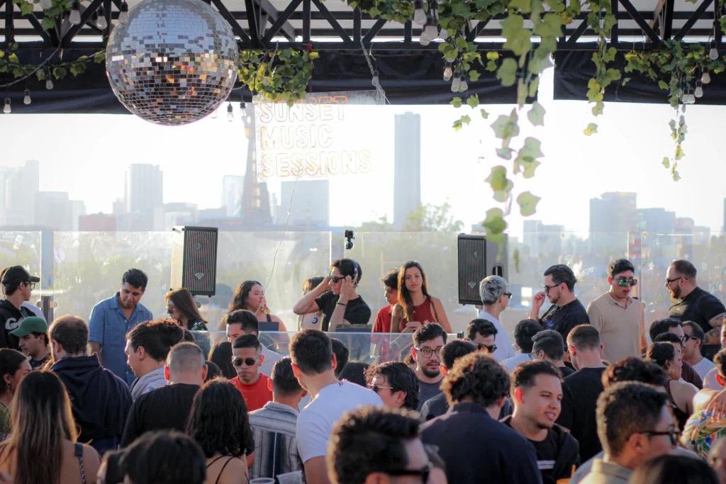 Guests watching the sunset during a rooftop party in Mexico City