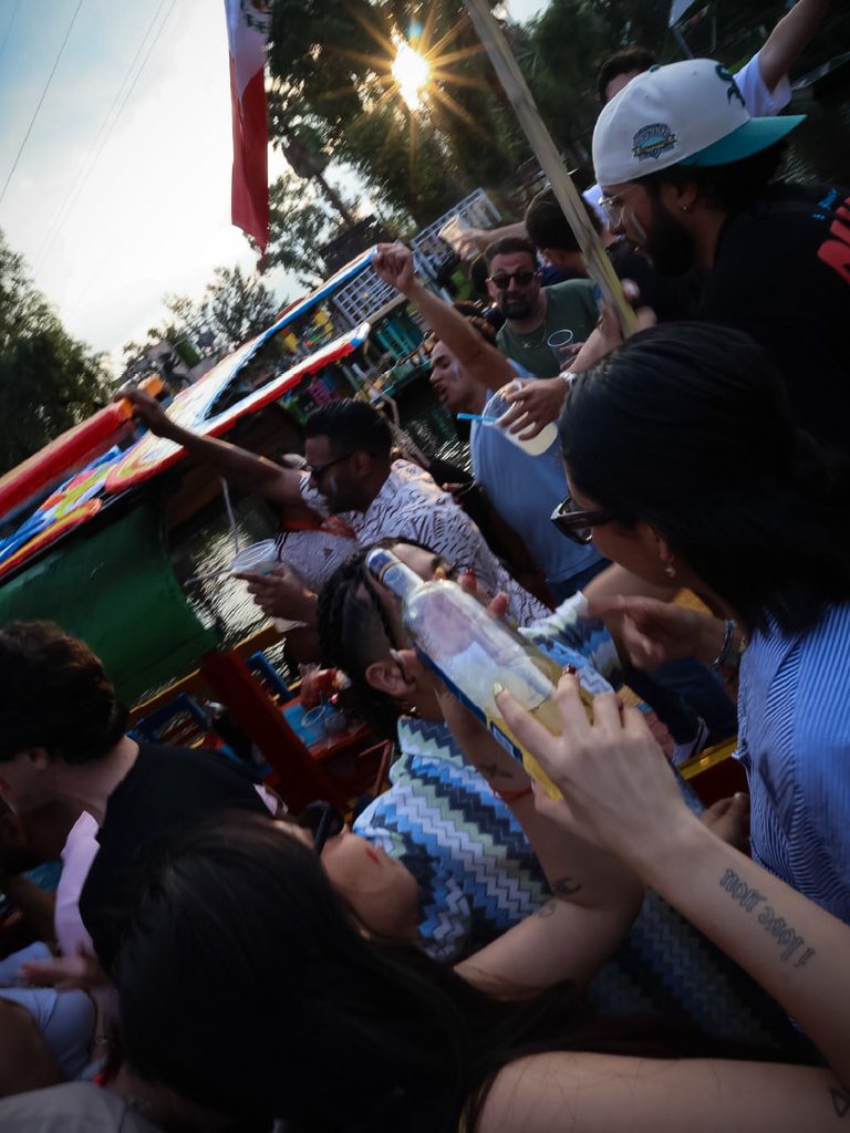 Group of travelers celebrating together on a Xochimilco boat tour