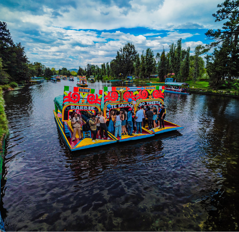 Trajinera boat ride through the Xochimilco canals at sunset